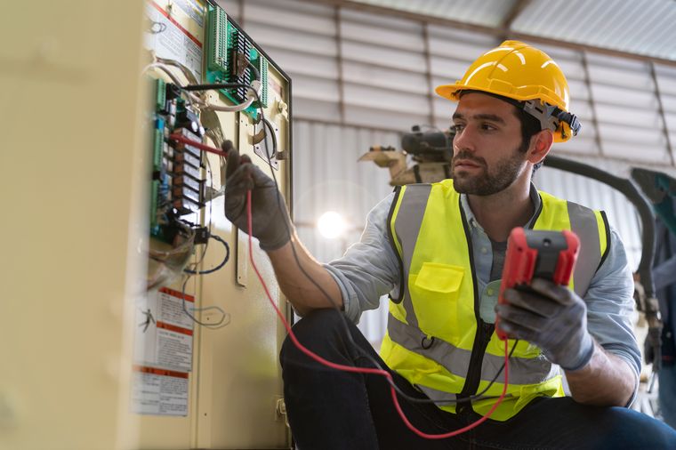 Electrical engineer testing a control panel